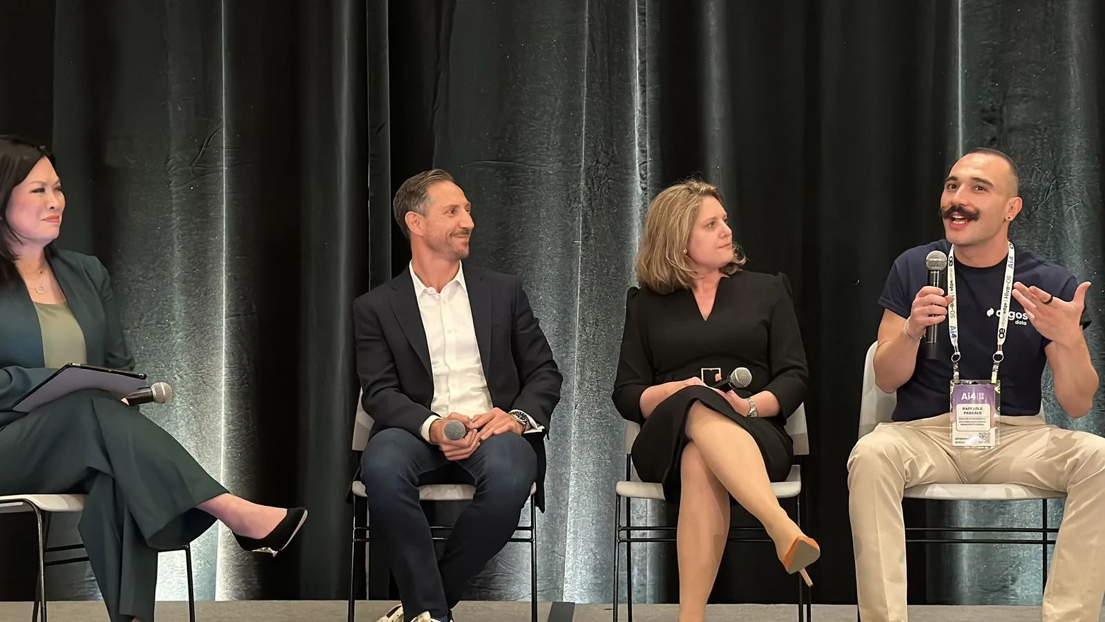 Raffaele Pascale of Argos Data speaking into a microphone alongside three other panelists on stage at Ai4 2026