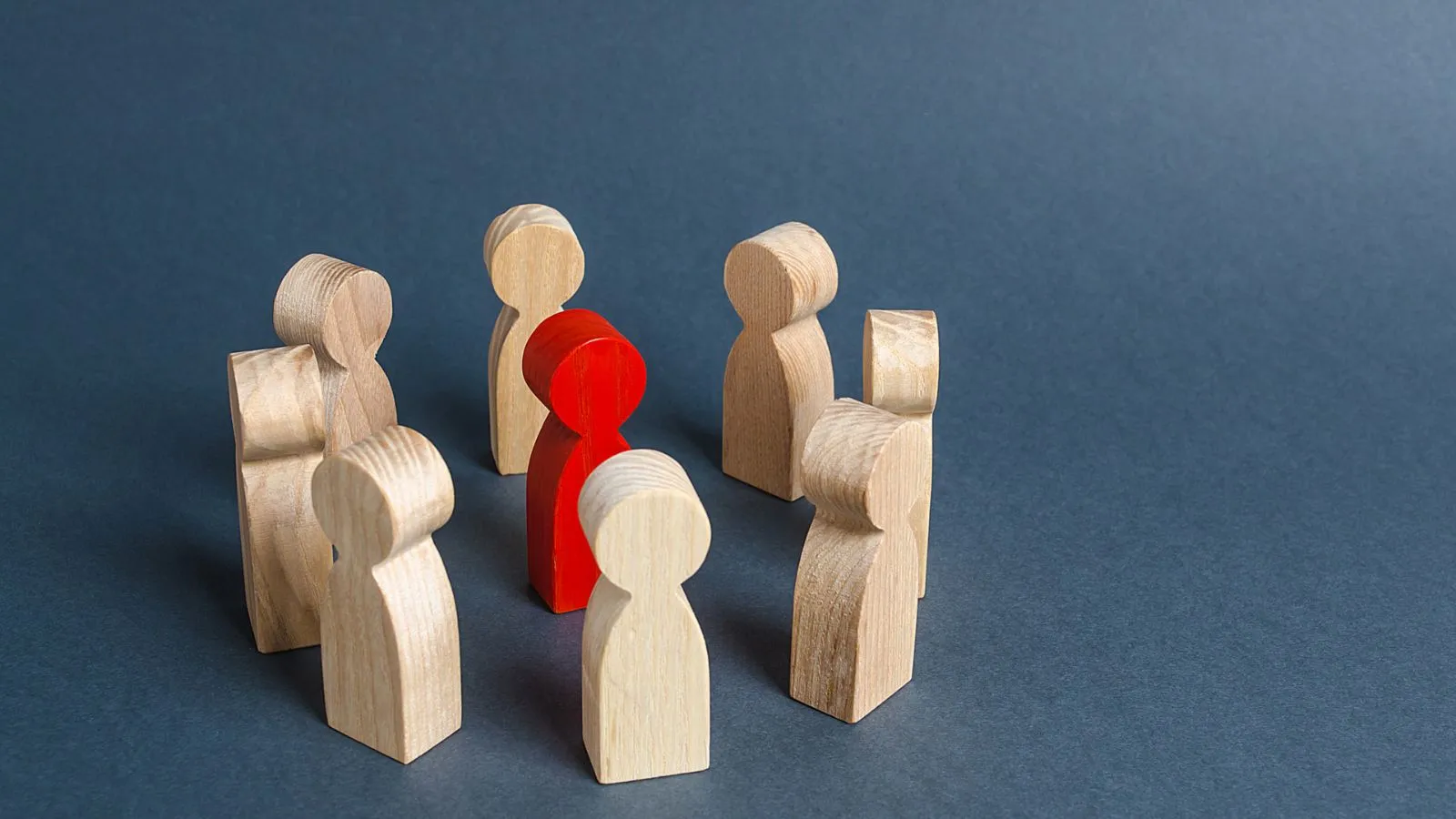 Red figure among white figures illustrating human-in-the-loop oversight in AI workflows.
